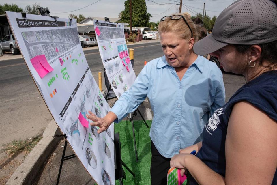 Beverly Kidwell talks with traffic planners Mia Candy, right, during a pop-up meeting to gain input from residents to help refine street design concepts in the Bystrom area of unincorporated south Modesto, Calif., on Friday, August 5, 2022.