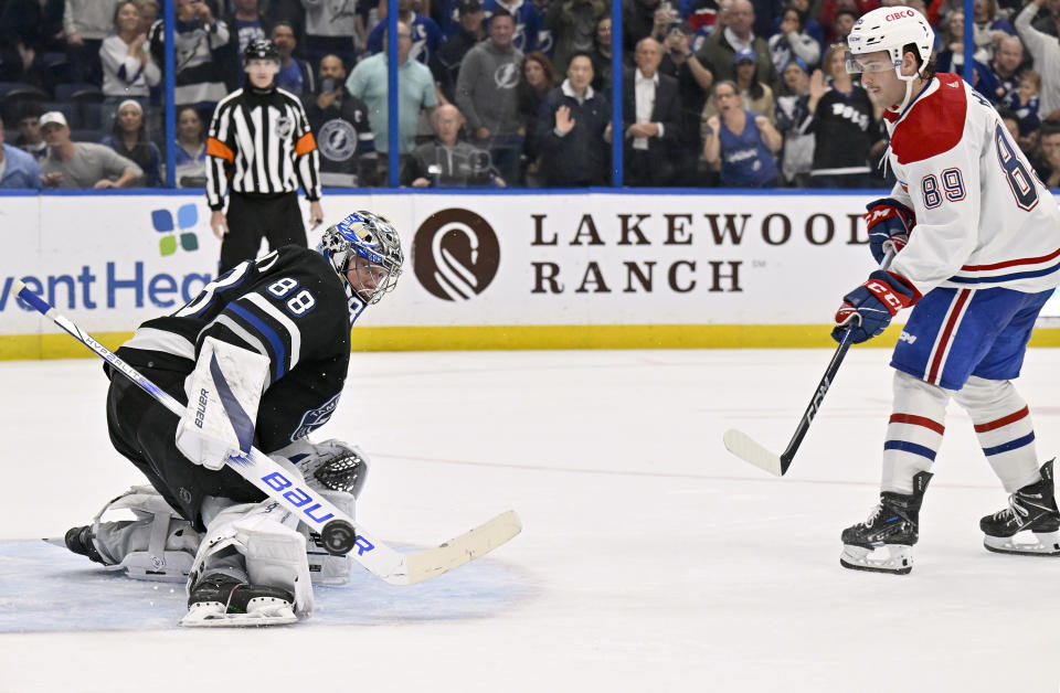 Tampa Bay Lightning goaltender Andrei Vasilevskiy (88) makes a save on a shot by Montreal Canadiens right wing Joshua Roy (89) during the shootout of an NHL hockey game Saturday, March 2, 2024, in Tampa, Fla. (AP Photo/Jason Behnken)