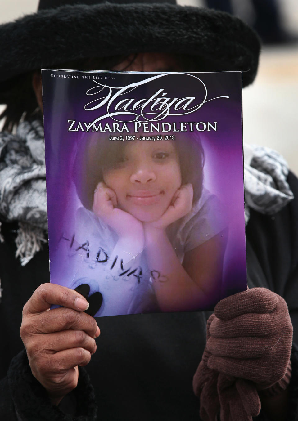 Minister Elnor Brown holds up a funeral program outside the Greater Harvest M.B. Church during the funeral of 15-year-old Hadiya Pendleton on Fe. 9, 2013, in Chicago, Illinois. (Photo: Scott Olson via Getty Images)