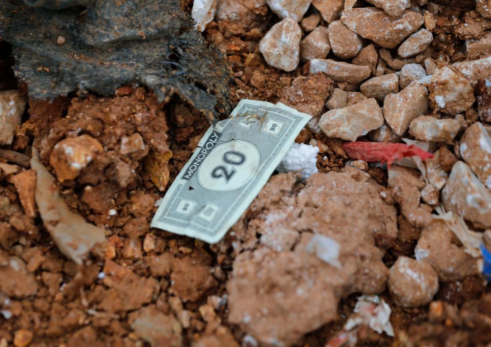 Monopoly money in a trash pile at the Springfield Noble Hill Sanitary Landfill in Willard on Thursday, March 2, 2023.