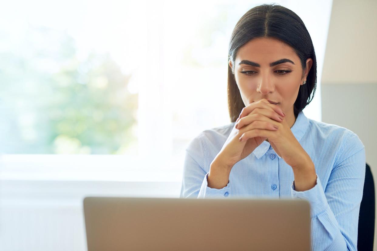 Woman looking at her laptop seriously