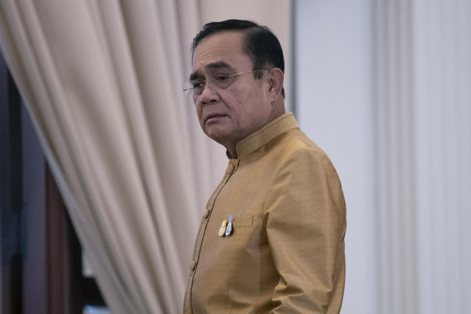 Thailand's Prime Minister Prayuth Chan-ocha leaves after a press conference at Government House in Bangkok, Thailand, Tuesday, Dec. 1, 2020. Thailand’s highest court is set to rule Wednesday, Dec. 2, 2020 on whether Prayuth has breached ethics clauses in the country’s constitution and should be ousted from his position. (AP Photo/Sakchai Lalit)