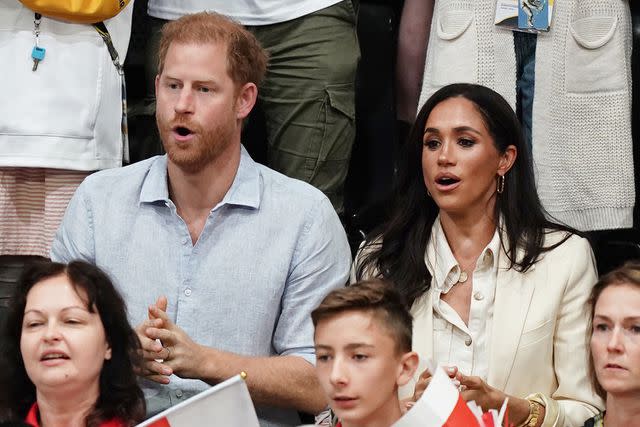 <p>Jordan Pettitt/PA Images via Getty Images</p> Prince Harry and Meghan Markle enjoy the sitting volleyball match on Friday