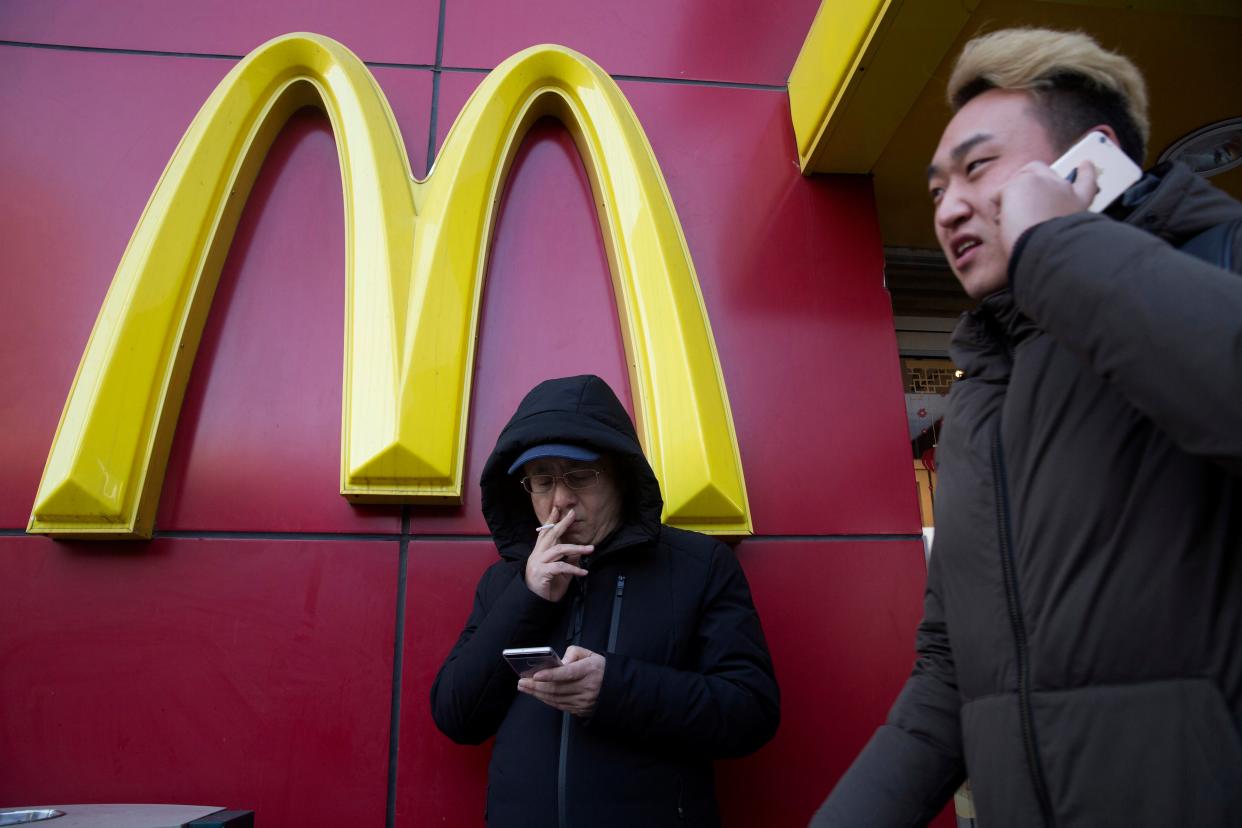 <p>File image: A man outside a McDonald outlet in Beijing  </p> (AP)