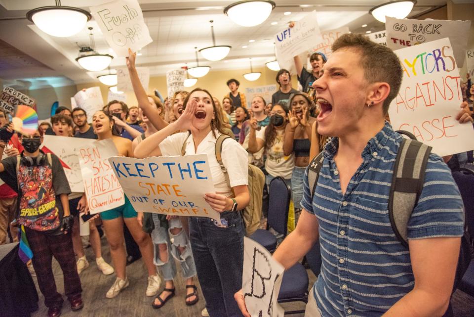 Students protest during an open forum discussion with Sen. Ben Sasse at Emerson Alumni Hall in Gainesville, Fla., on Monday, Oct. 10, 2022.