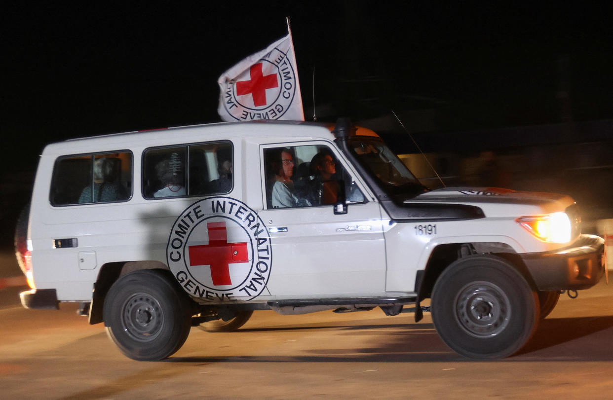 A Red Cross vehicle, as part of a convoy believed to be carrying hostages abducted by Hamas militants during the October 7 attack on Israel, arrives at the Rafah border, amid a hostages-prisoners swap deal between Hamas and Israel, as seen from southern Gaza Strip November 24, 2023. / Credit: IBRAHEEM ABU MUSTAFA / REUTERS