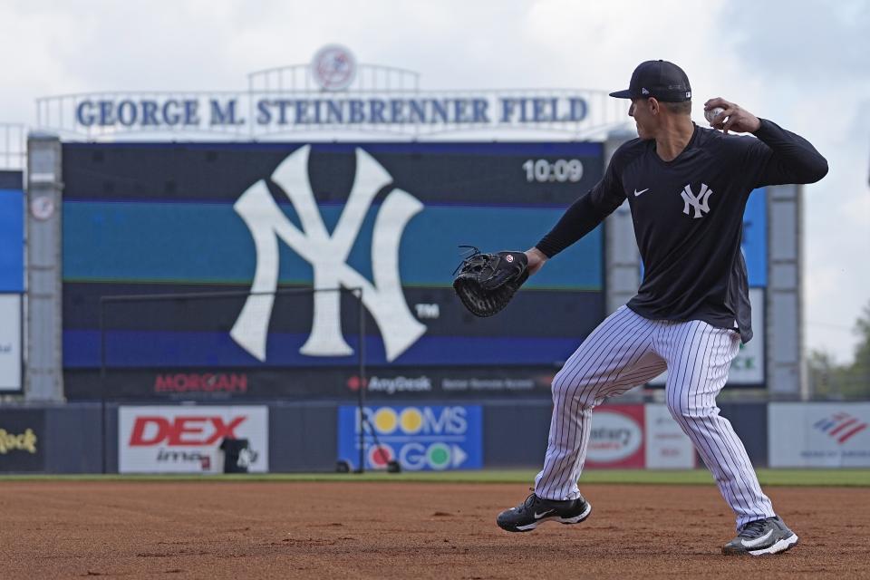 New York Yankees first baseman Anthony Rizzo fields ground balls during batting practice before a spring training baseball game against the Washington Nationals Wednesday, March 1, 2023, in Tampa, Fla. (AP Photo/David J. Phillip)