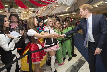 Britain's Prince Harry greets a well wisher as he takes part in a charity trading day at ICAP in support of his charity Sentebale, in London, December 7, 2016. REUTERS/Geoff Pugh/Pool