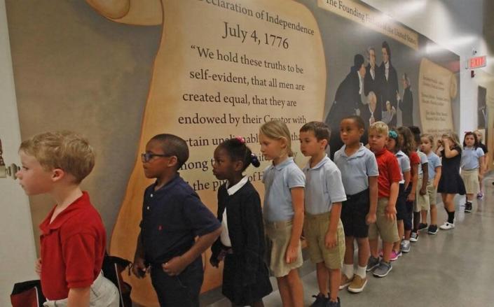 First-graders line up in a hallway at Thales Academy in Knightdale, N.C. on July 20, 2017.