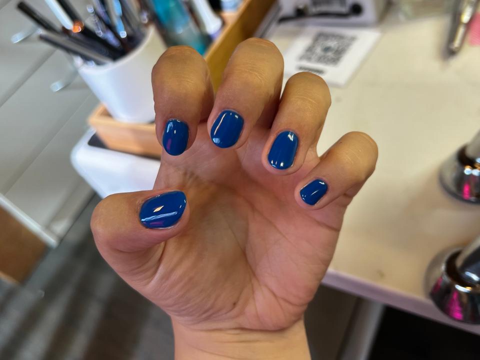 hand posing to show off a blue japanese gel manicure