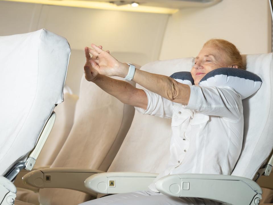 Woman stretching in her seat.