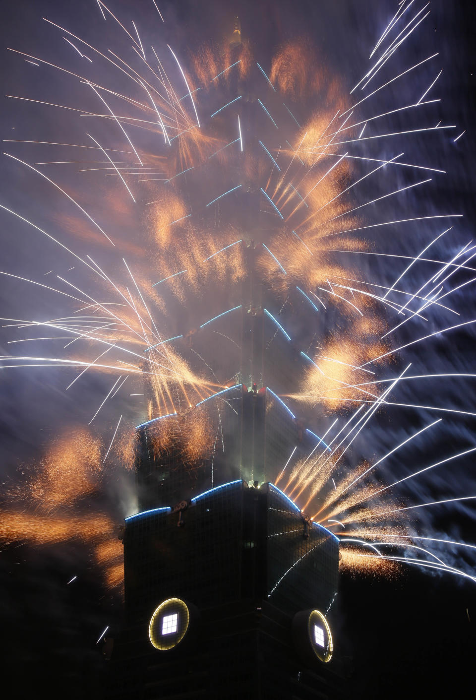 A massive fireworks display launches from the Taipei101 skyscraper during the New Year's Eve celebrations in Taipei, Taiwan, Tuesday, Dec. 31, 2013. (AP Photo/Wally Santana)