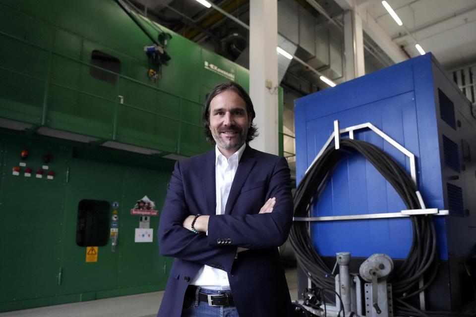 Dairy cooperative managing director Bernhard Pointner poses in front of a turbine generator in Piding near Munich, Germany, Friday, July 15, 2022. The Molkerei Berchtesgadener Land has stockpiled 200,000 liters of fuel oil so it can continue to produce electricity and steam if natural gas supplies to its turbine generator are cut off. (AP Photo/Matthias Schrader)