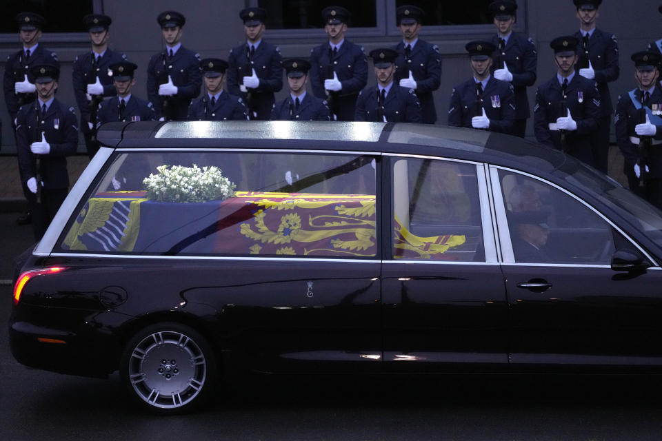 The coffin of Queen Elizabeth II carried in a State Hearse is leaving RAF Northolt in London, to be taken to Buckingham Palace, Tuesday, Sept. 13, 2022. Queen Elizabeth II, Britain's longest-reigning monarch and a rock of stability across much of a turbulent century, died Thursday Sept. 8, 2022, after 70 years on the throne. She was 96. (AP Photo/Kirsty Wigglesworth, Pool)