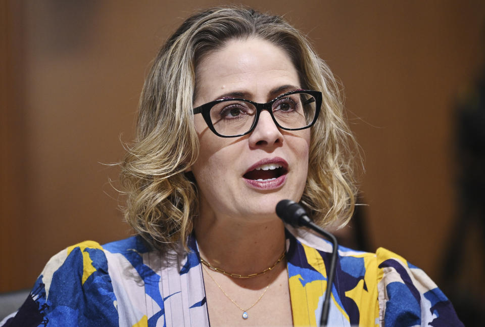 FILE - Sen. Kyrsten Sinema, D-Ariz., speaks during a Senate Finance Committee hearing on Oct. 19, 2021 on Capitol Hill in Washington. Twenty years ago, a Green Party activist running for city council in Phoenix named Kyrsten Sinema likened the practice of raising campaign cash to “bribery.” Now a first-term Arizona senator, she no longer has such qualms, raising nearly $500,000 in donations from financial and pharmaceutical sector this year. (Mandel Ngan/Pool via AP, File)