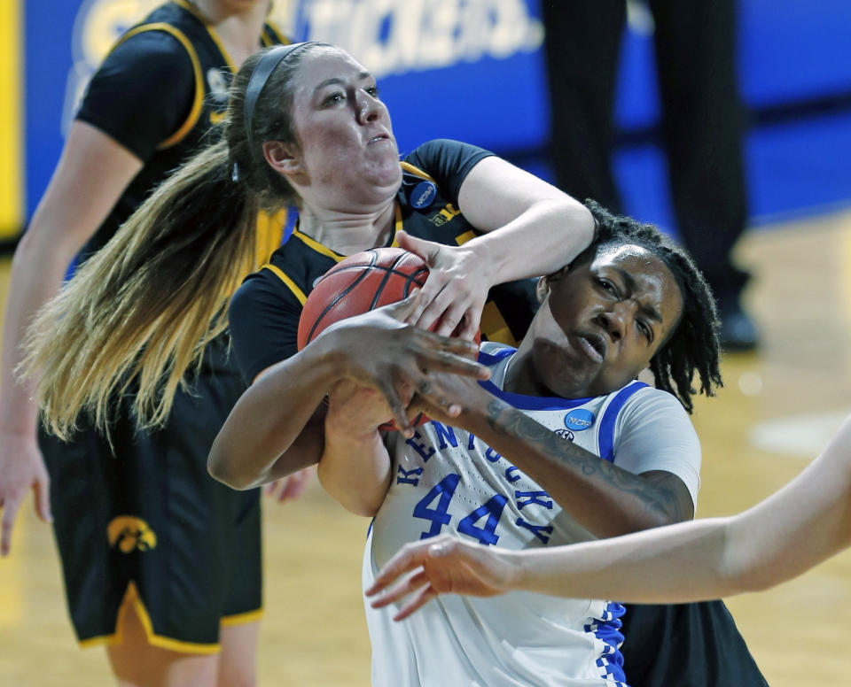 Iowa guard McKenna Warnock (14) ties up Kentucky guard Dre'una Edwards (44) during the first half of a college basketball game in the second round of the women's NCAA tournament at the Greehey Arena in San Antonio, Tuesday, March 23, 2021. (AP Photo/Ronald Cortes)