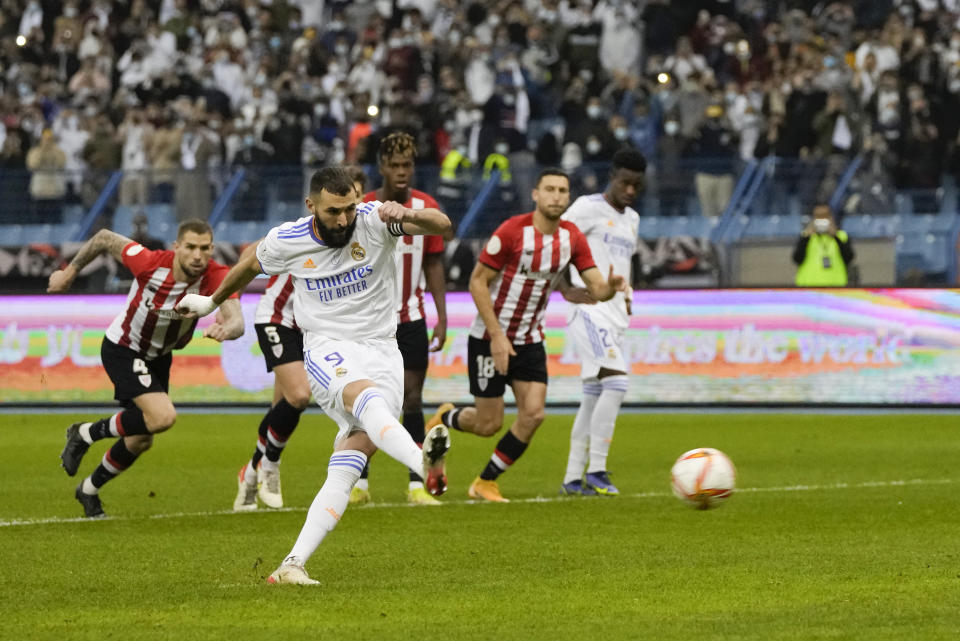 Real Madrid's Karim Benzema scores from a penalty kick during the Spanish Super Cup final soccer match between Real Madrid and Athletic Bilbao at King Fahd stadium in Riyadh, Saudi Arabia, Sunday, Jan. 16, 2022. (AP Photo/Hassan Ammar)