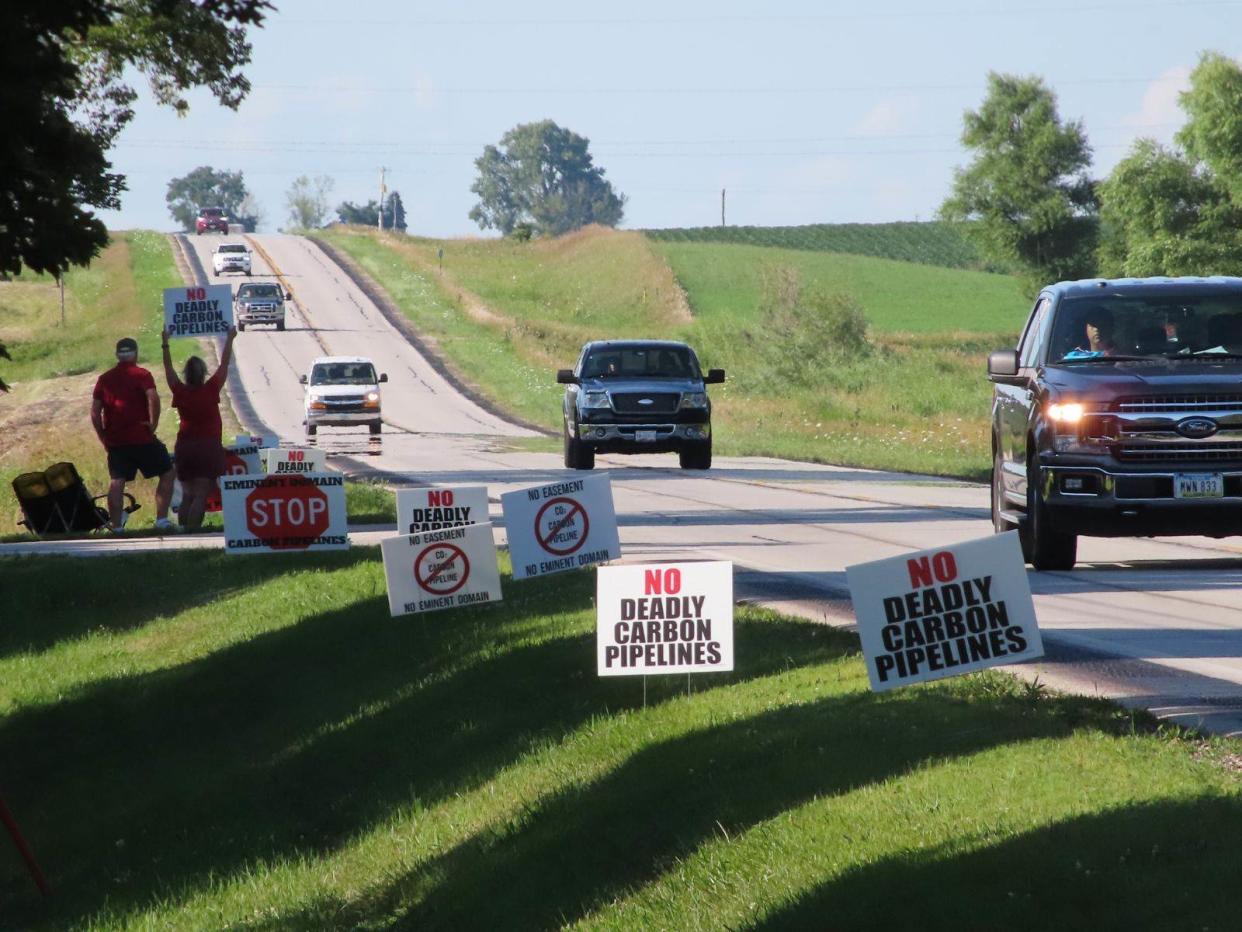 About 15 opponents to Summit Carbon Solutions' $5.5 billion carbon-capture pipeline line the road to Bruce Rastetter 's farm in Alden in late July, where guests were gathering for Rastetter's annual summer party. Rastetter spun off the pipeline company from his business, Summit Agricultural Group.