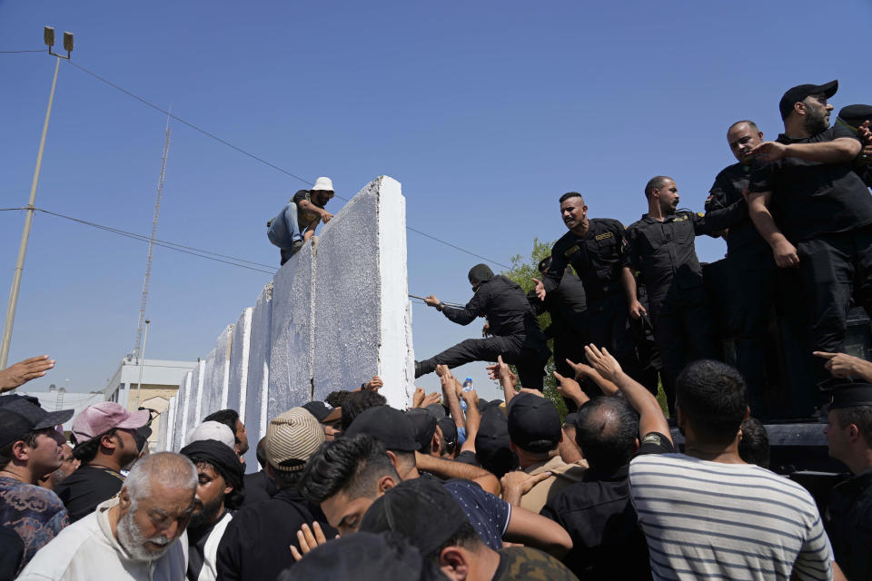 Iraqi security forces prevent protesters from entering the Federal Court during a demonstration in Baghdad, Iraq, Monday, Aug. 29, 2022. (AP Photo/Hadi Mizban)