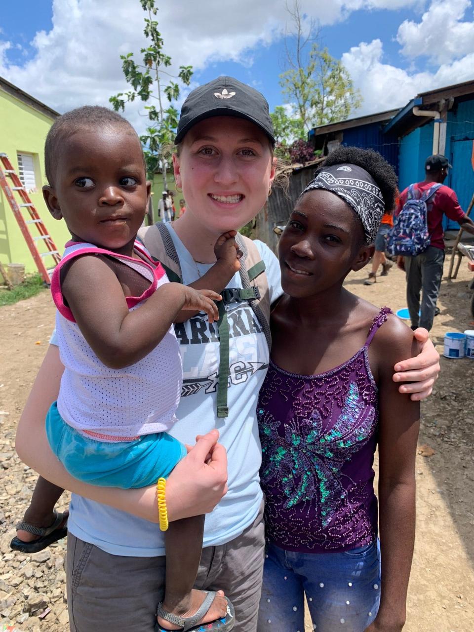 Lake Center Christian School senior Marisa Varner, seen during a 2023 missionary trip where she evangelized with a 17-year-old, right, and the woman's 1-year-old son, soon will return to the Dominican Republic with the school’s mission team.
