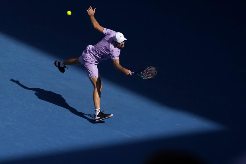 Hubert Hurkacz of Poland plays a backhand return to Sebastian Korda of the U.S. during their fourth round match at the Australian Open tennis championship in Melbourne, Australia, Sunday, Jan. 22, 2023. (AP Photo/Mark Baker)