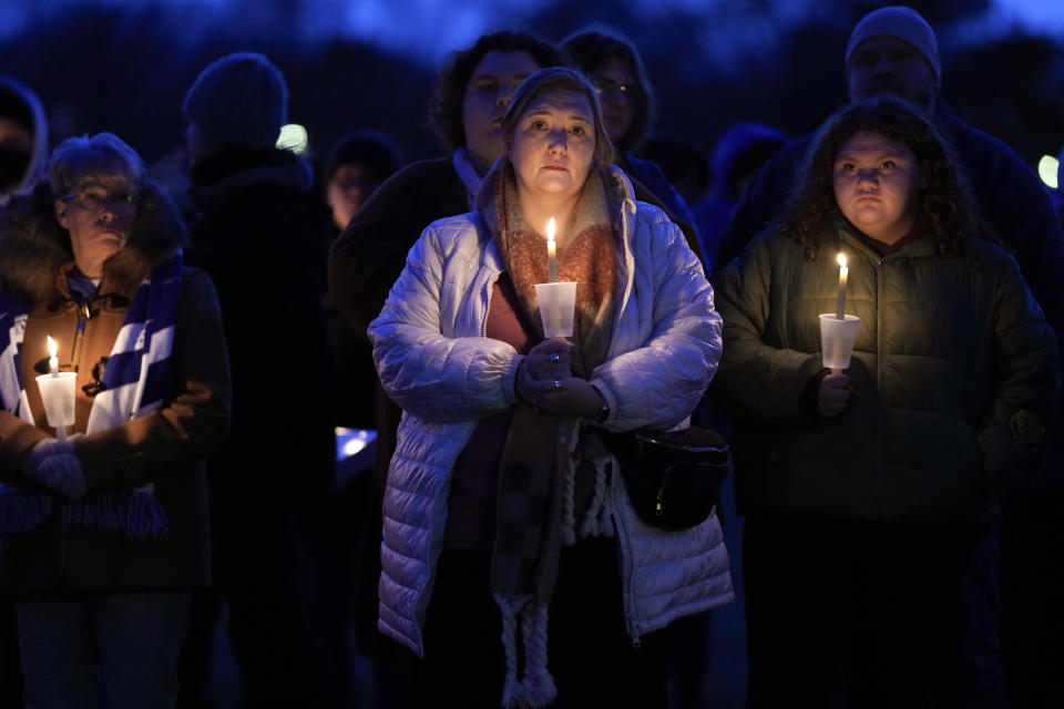 Local residents pray during a candlelight vigil following a shooting at Perry High School, Thursday, Jan. 4, 2024, in Perry, Iowa. (AP Photo/Charlie Neibergall)