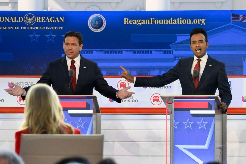 Florida Gov.ÊRon DeSantis (left) and businessmanÊVivek Ramaswamy speak during the FOX Business Republican presidential primary debate at the Ronald Reagan Presidential Library and Museum.