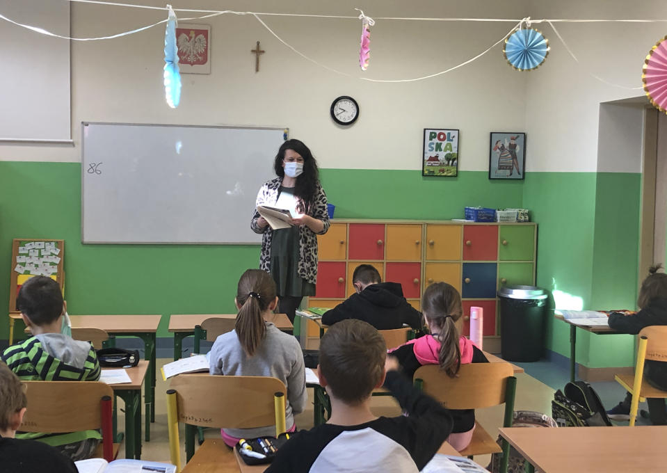 Polish elementary school teacher Patrycja Swistowska teaches her second grade class at a school in Warsaw, Poland, Friday Feb. 12, 2021. As Poland began vaccinating teachers on Friday, many say they are unhappy that they are getting AstraZeneca vaccines against the coronavirus, rather than the Pfizer shots earmarked for health care workers and the elderly. Nearly a year into the pandemic, many Europeans are desperate to get vaccinated and return to normal life. But many don't want just any vaccine. (AP Photo/Vanessa Gera)