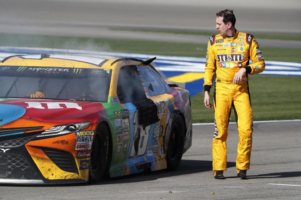 Kyle Busch walks away from his smoking car in pit lane at the end of the NASCAR Cup Series auto race at Las Vegas Motor Speedway on Sunday, March 12, 2017, in Las Vegas. (Steve Marcus/Las Vegas Sun via AP)