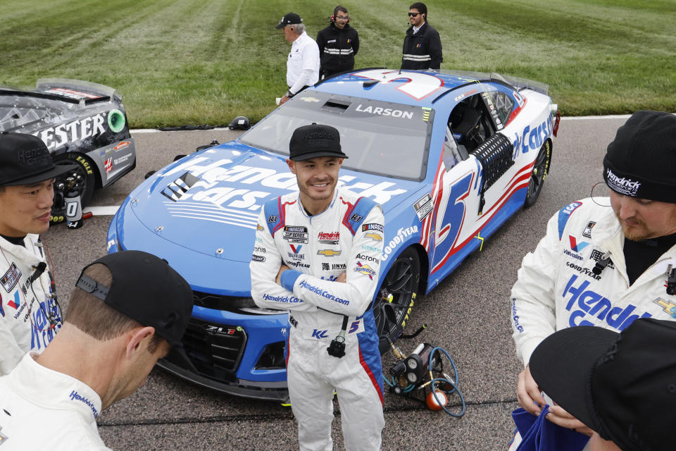 Kyle Larson, center, visits with his pit crew along pit road before a NASCAR Cup Series auto race at Kansas Speedway in Kansas City, Kan., Sunday, May 5, 2024. (AP Photo/Colin E. Braley)