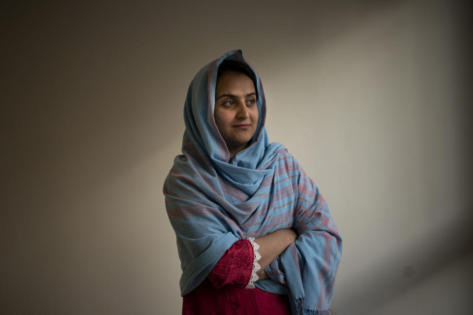 Behishta Arghand, a news anchor for the privately owned broadcaster Tolo News, poses for a photo inside a compound in Doha, Qatar on Sunday, Aug. 29, 2021. She interviewed a Taliban official days after they took control of Kabul in mid-August. Arghand fled the country after the interview, unwilling to take any chances about the Taliban's promises of greater openness. (AP Photo/Bram Janssen)