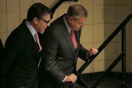 Republican U.S. presidential candidates, former Texas Governor Rick Perry (L) and U.S. Senator Lindsey Graham (R), wait offstage for their turns to speak during the Voters First Presidential Forum in Manchester, New Hampshire August 3, 2015. REUTERS/Brian Snyder