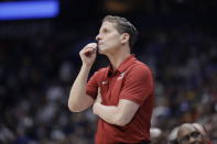 FILE - In this March 11, 2020, file photo, Arkansas head coach Eric Musselman watches the action in the first half of an NCAA college basketball game against Vanderbilt in the Southeastern Conference Tournament in Nashville, Tenn. As thousands of college athletes and coaches across the country try to adjust after the sudden suspensions of entire seasons of competition and perhaps more so the camaraderie of daily practices, training sessions and team meals, communication specialists and mental health professionals are encouraging those involved to allow these young men and women to go through the stages of grieving as needed. "I think for all of us in college athletics the No. 1 focus always has to be on the student's well-being," Musselman said. (AP Photo/Mark Humphrey, File)