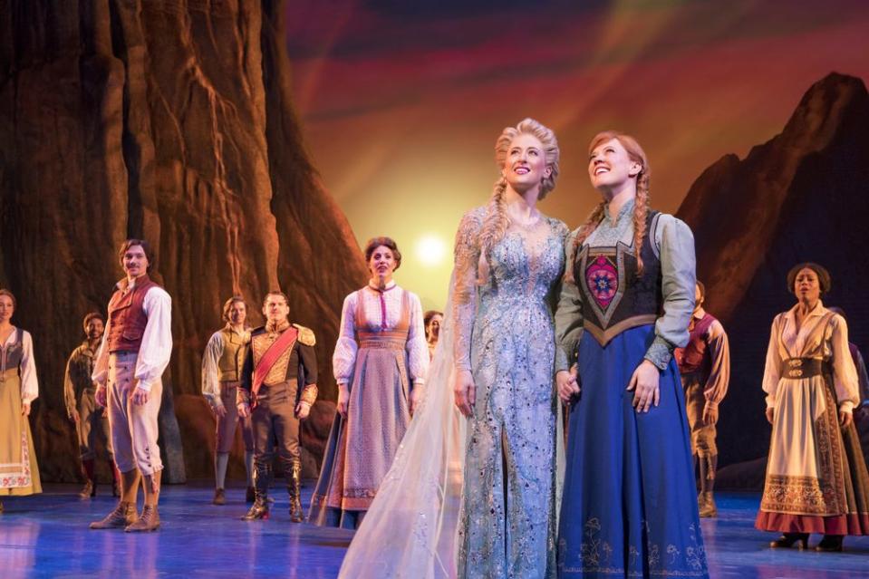 Caissie Levy (as Elsa) and Patti Murin (as Anna), along with the company of <em>Frozen</em> on Broadway.