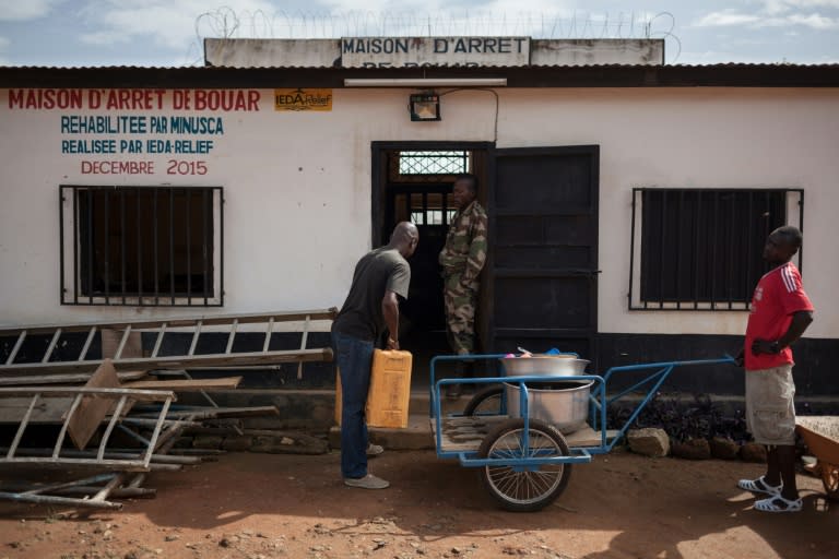 Doing porridge in CAR: A man delivers breakfast mash at Bouar detention centre