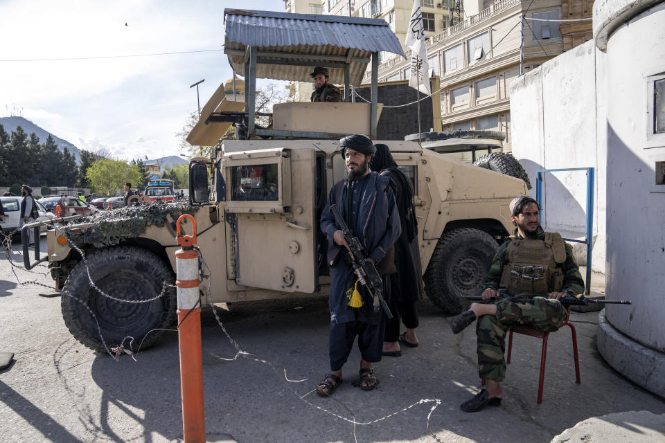 Taliban fighters stand guard at the explosion site, near the Foreign Ministry in Kabul, Afghanistan, Monday, March 27, 2023. A suicide bomber has struck near the foreign ministry in the Afghan capital, killing at least six people and wounding about a dozen. (AP Photo/Ebrahim Noroozi)