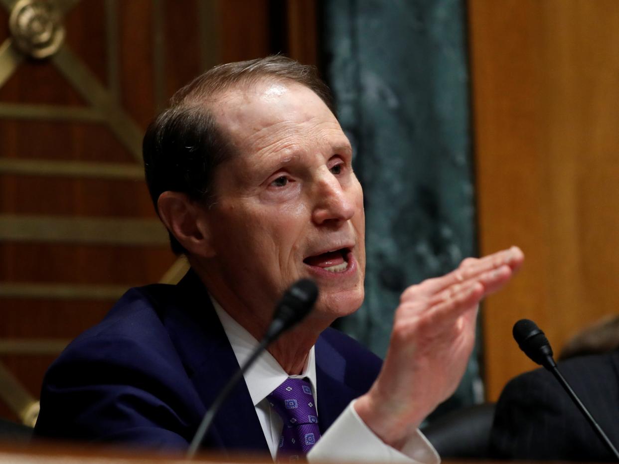 Senator Ron Wyden, L, (D-OR) questions Commerce Secretary Wilbur Ross as Sen. Orrin Hatch, R, (R-UT) listens on during a Senate Finance hearing on 