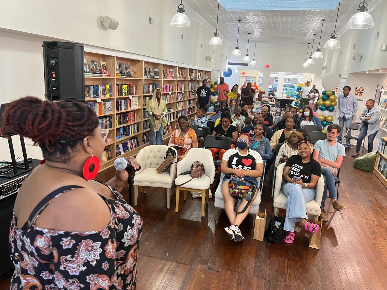 Poet Paula G (Paula Akinwole) hosts an open mic and poetry night at Resist Booksellers in Petersburg, Virginia.