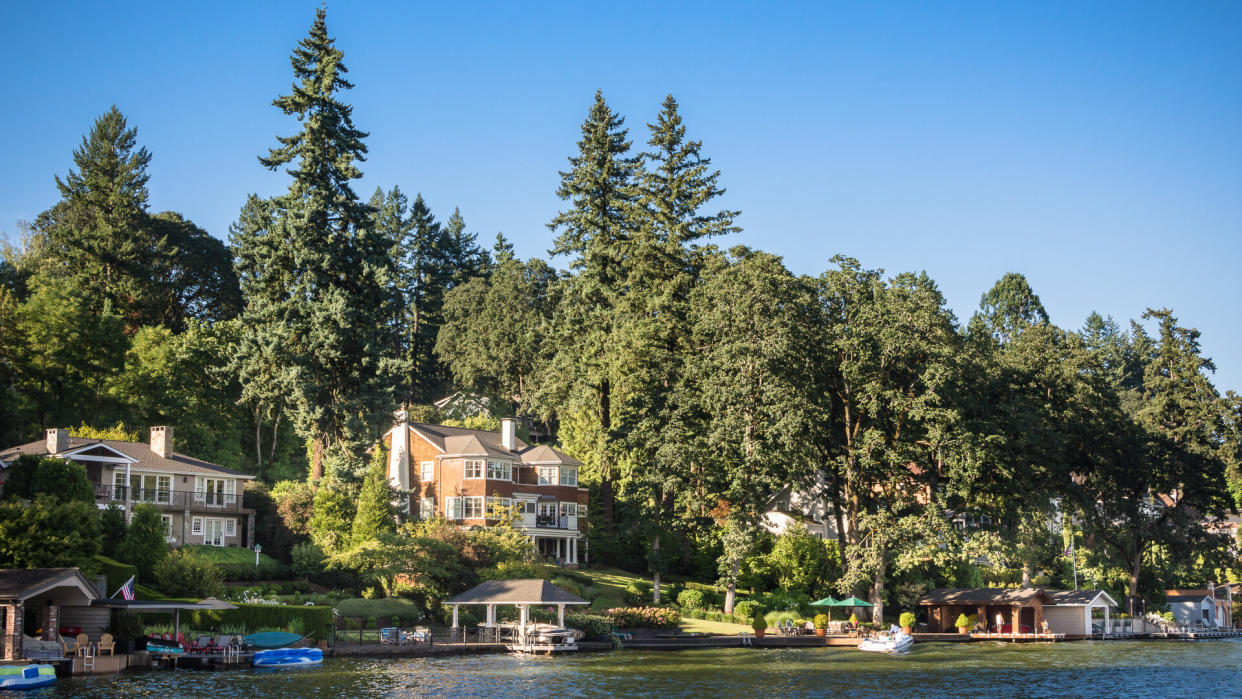 Wealthy home owners enjoy their manshions with boat houses along the beautiful shores of Lake Oswego in Oregon.