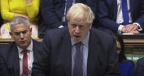 Britain's Prime Minister Boris Johnson delivers a statement to lawmakers inside the House of Commons in London, Saturday Oct. 19, 2019. At a rare weekend sitting of Parliament, Johnson implored legislators to ratify the Brexit deal he struck this week with the other 27 EU leaders. Secretary of State for Exiting the European Union, Stephen Barclay, sitting at left. (House of Commons via AP)