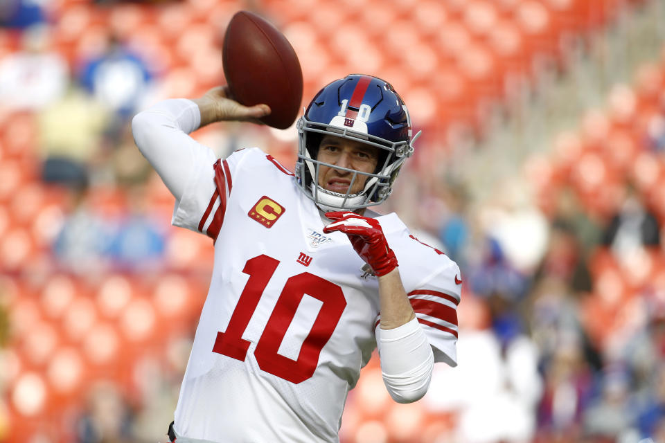 FILE - In this Dec. 22, 2019 file photo New York Giants quarterback Eli Manning works out prior to an NFL football game against the Washington Redskins in Landover, Md. Manning, who led the Giants to two Super Bowls in a 16-year career that saw him set almost every team passing record, has retired. The Giants said Wednesday, Jan. 22, 2020 that Manning would formally announce his retirement on Friday. (AP Photo/Patrick Semansky, file)