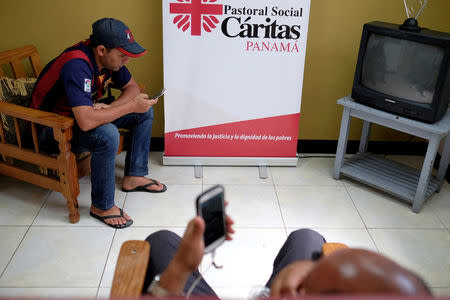 Cuban migrants listen and monitor international news at the Caritas shelter in Panama City, Panama, January 13, 2017. REUTERS/Melchor Herrera