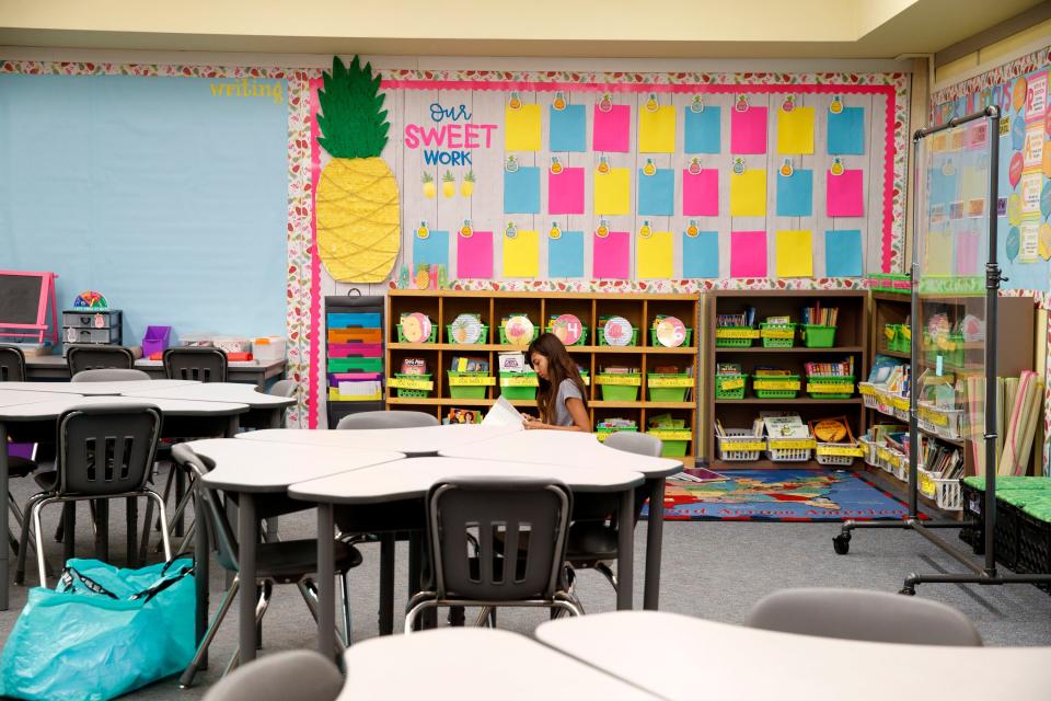 Isabella Diener helps organize her mom's third-grade classroom at Della S. Lindley Elementary School in Thousand Palms on Tuesday.