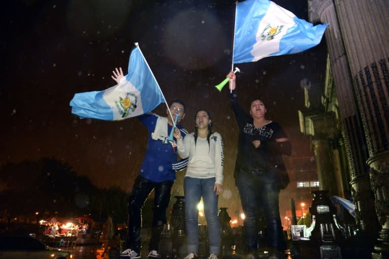 Guatemalans celebrate after Congress voted unanimously to strip embattled President Otto Perez of immunity in Guatemala City on September 1, 2015