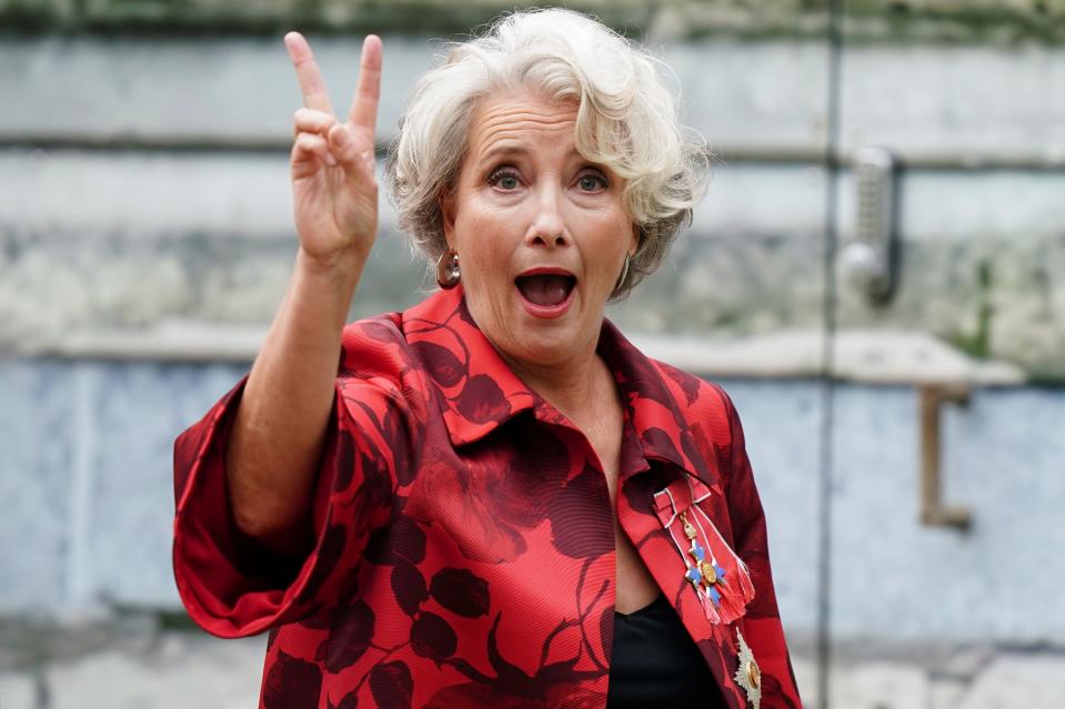 Emma Thompson flashes a peace sign ahead of the coronation.