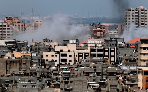 A picture taken from Gaza City on May 29, 2018, shows a smoke billowing in the background following an Israeli air strike  - Credit: THOMAS COEX/AFP/Getty Images