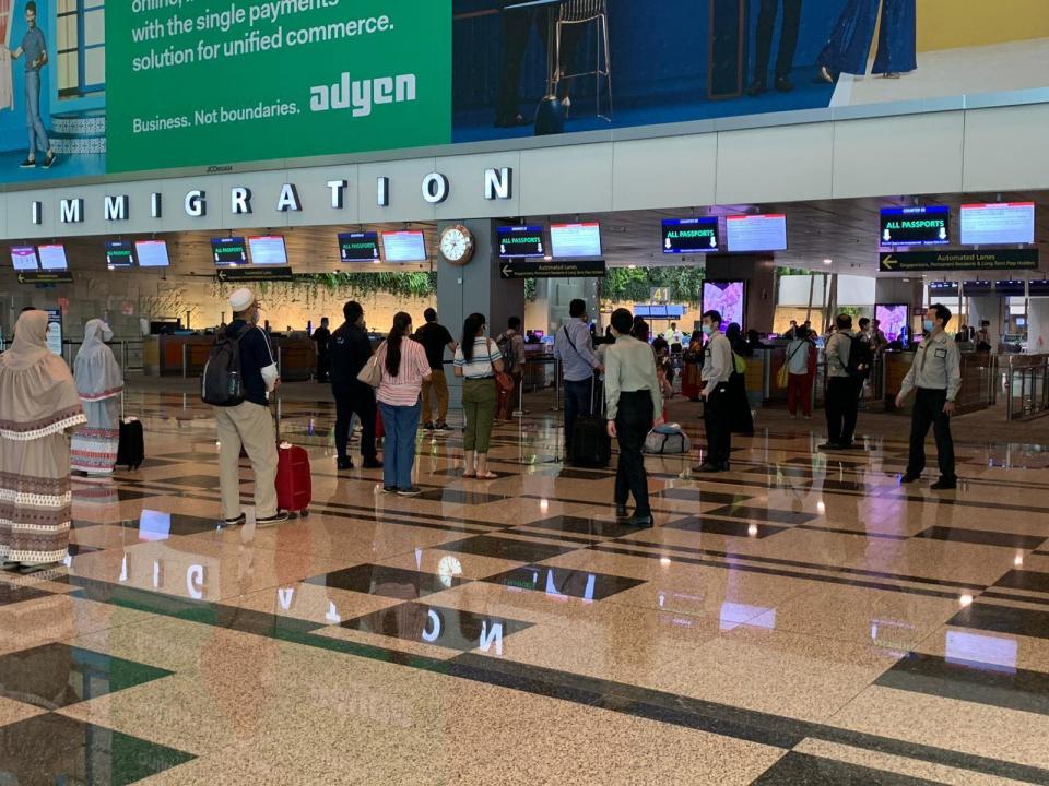 Returning Singapore citizens and residents from India clearing immigration at Changi Airport. (PHOTO: Ministry of Transport)