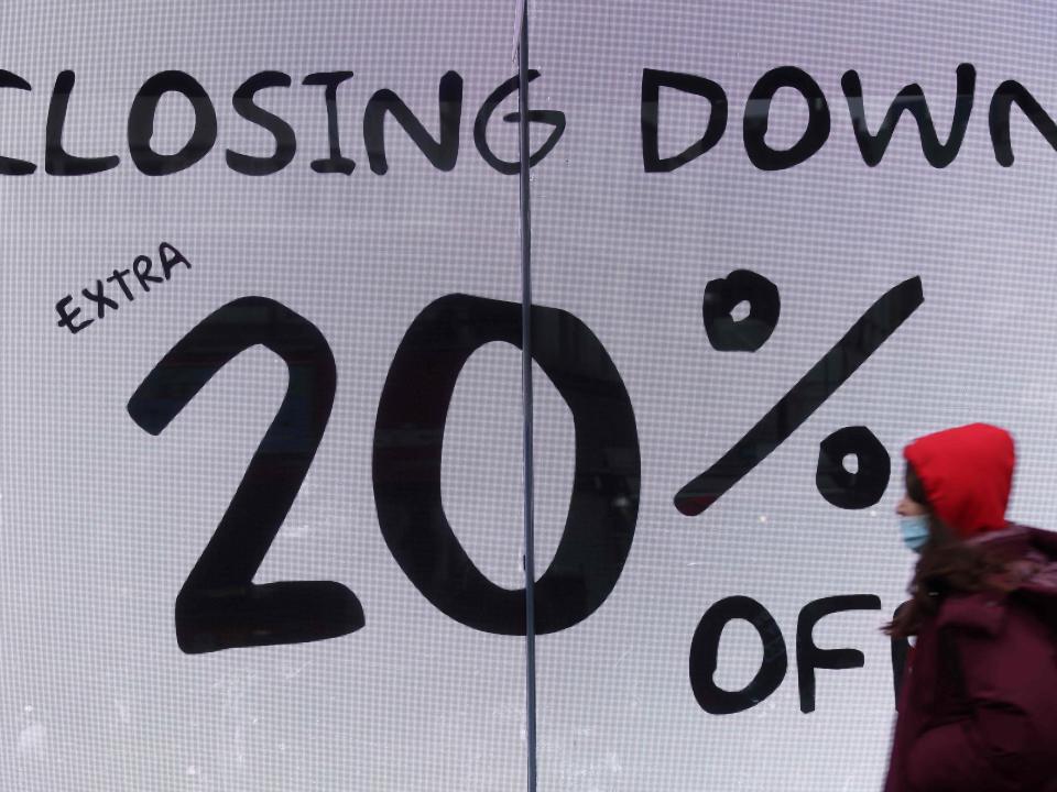 A shopper passes a ‘closing down sale’ sign as she walks in central London (AFP via Getty Images)