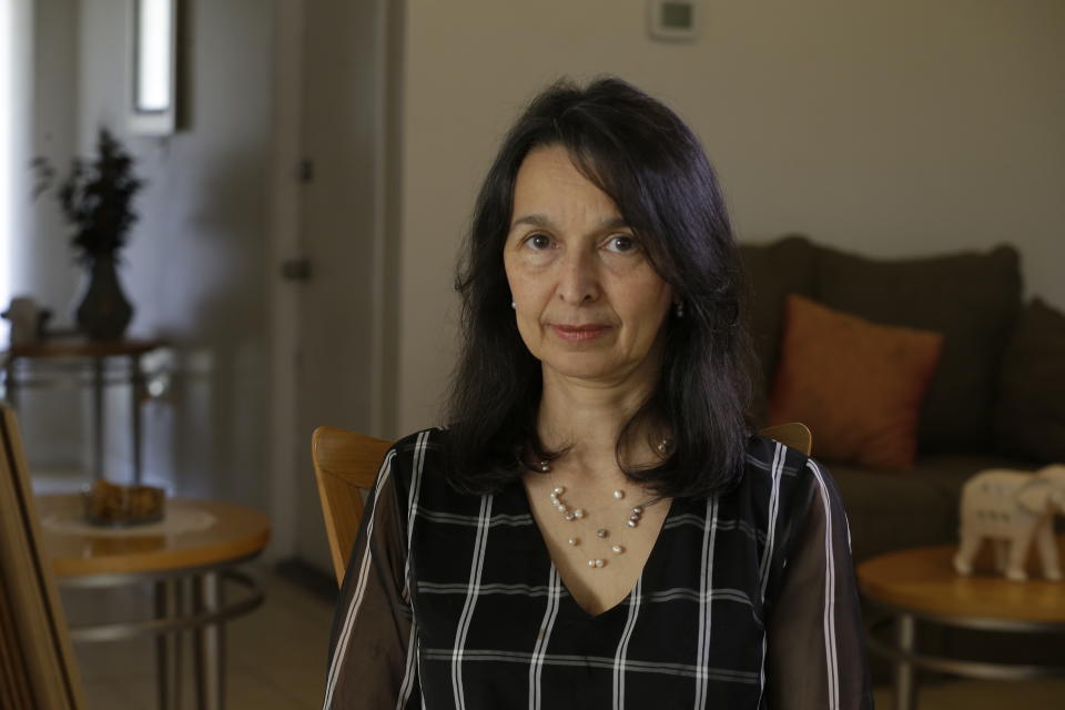 In this March 6, 2020 photo, Cioly Zambrano poses for a photo in her home in Orlando, Florida. Zambrano, is one of 32 jurists named to the Supreme Court by opposition leader Juan Guaido, immediately converting her and her family into high-priority targets for arrest. (AP Photo/Cody Jackson)