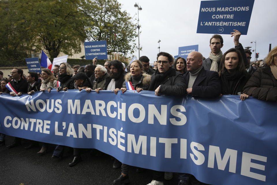 Thousands gather for a march against antisemitism in Paris, France, Sunday, Nov. 12, 2023. French authorities have registered more than 1,000 acts against Jews around the country in a month since the conflict in the Middle East began. The banner reads: "We are marching against Antisemitism."(AP Photo/Christophe Ena)